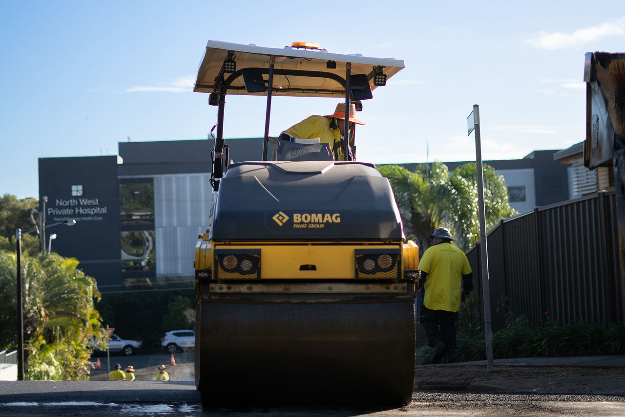 Road resurfacing in Frater Street Everton Park featuring a worker on a road surfacing vehicle.