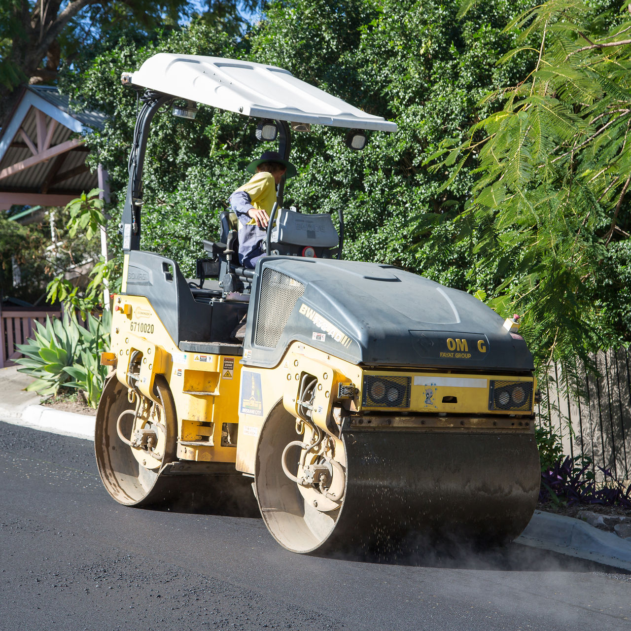 A worker working on road surfacing in Sawtell Lane.