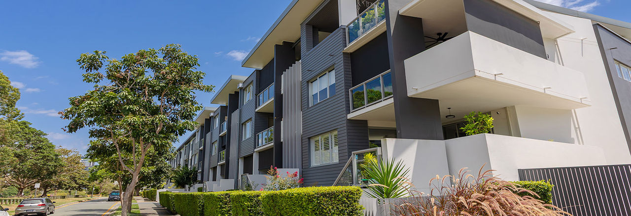 Multi unit dwellings seen from the road at Bulimba