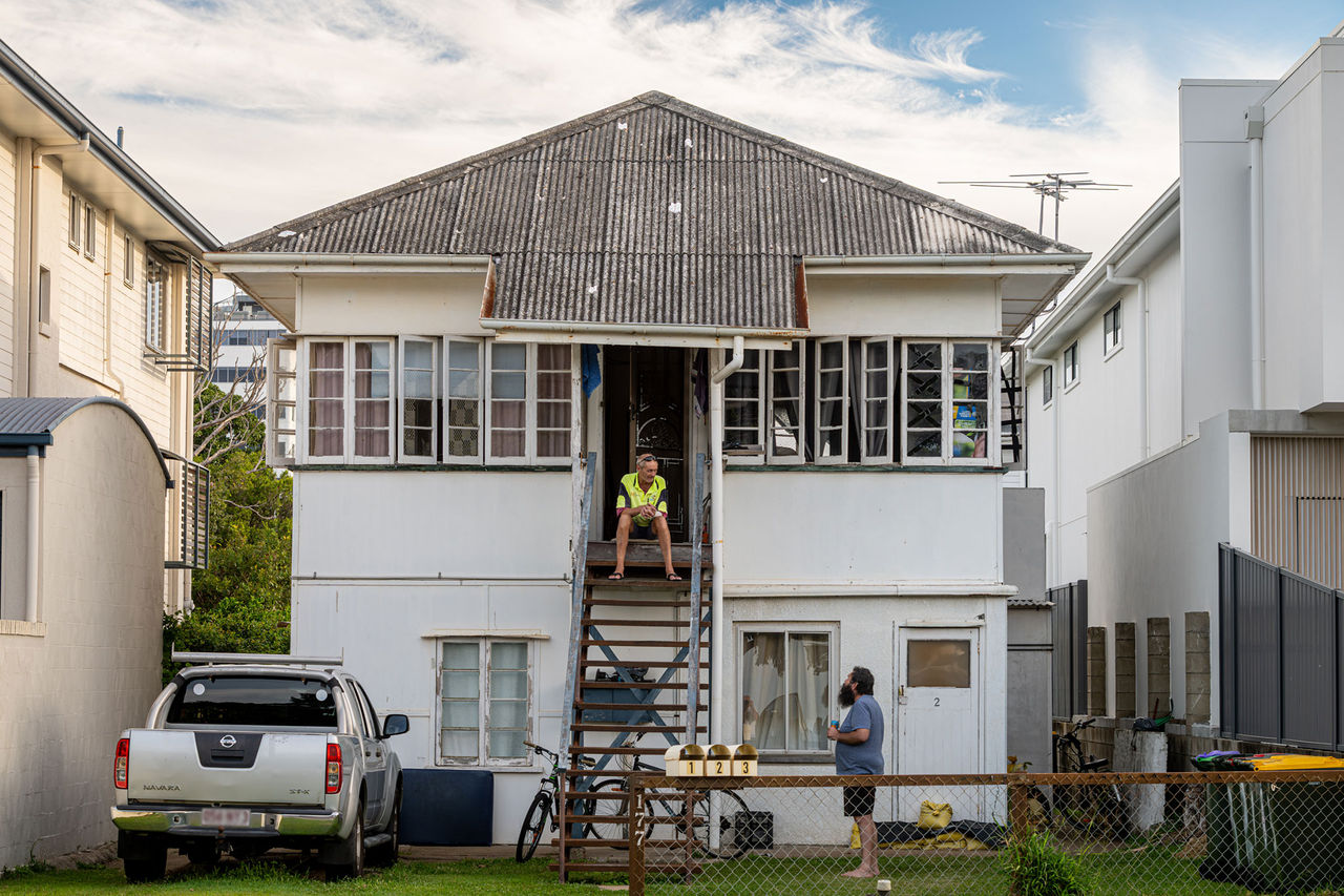 ord Mayor's Photographic Awards 2026 - Open Category 2nd Place Winner - Nigel Wesley - Shooting the breeze. Two men talking in the front yard of a house.