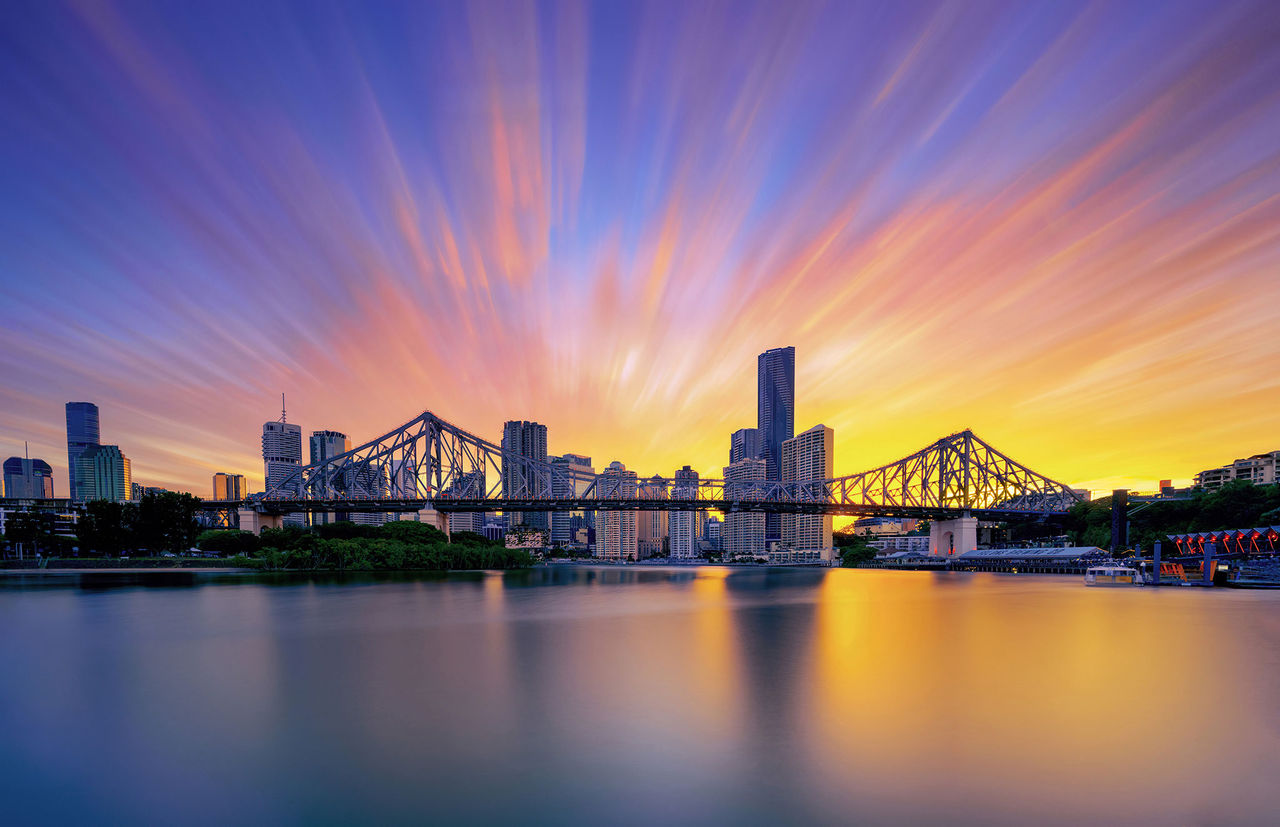 Lord Mayor's Photographic Awards 2026 - Brisbane Postcards Collection Winner - Wendy Klein - Brisbane Afterglow. Radiating sunset clouds frame Brisbane's skyline and Story Bridge creating a dramatic evening scene above the Brisbane River.