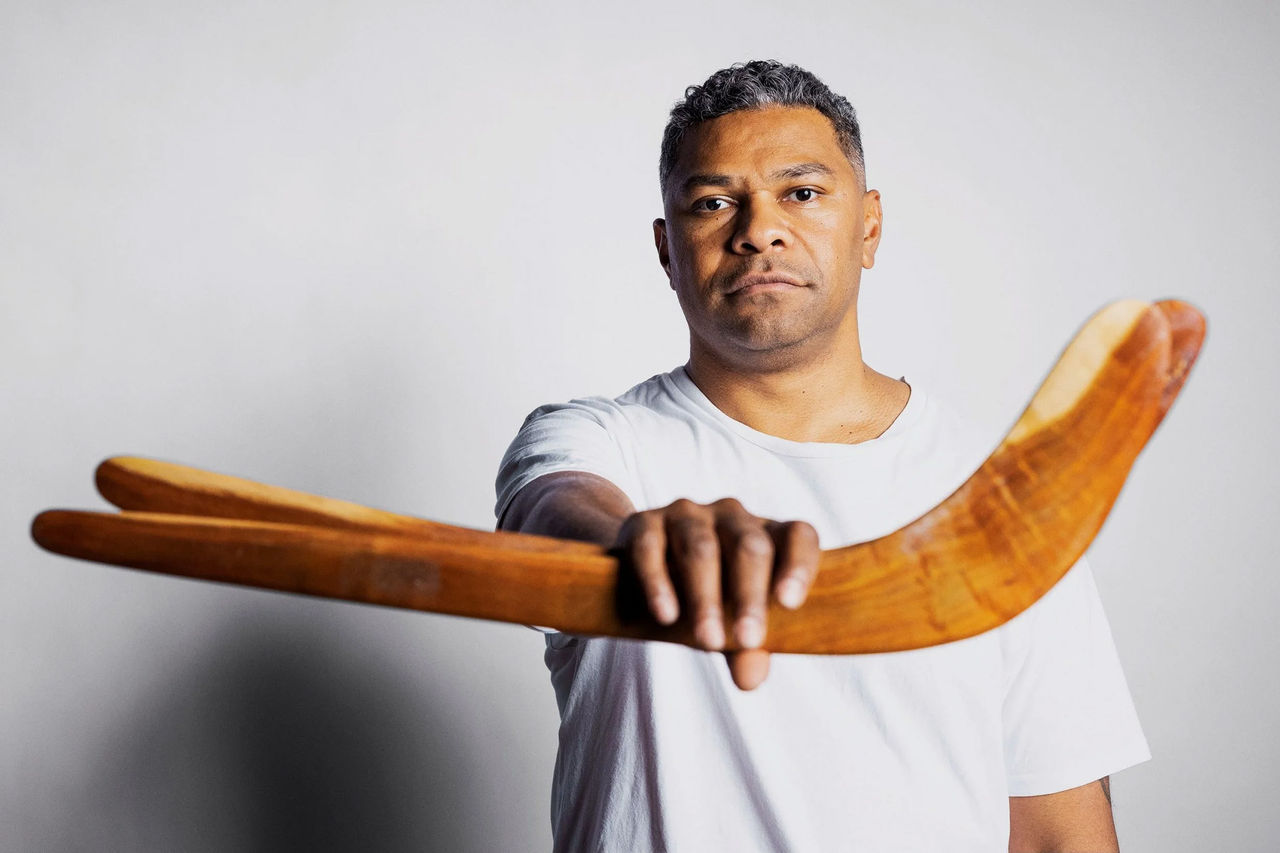Fred Leone - mentor for The QUBE Effect 2026. Fred is holding 2 boomerangs in the forefront of the image.