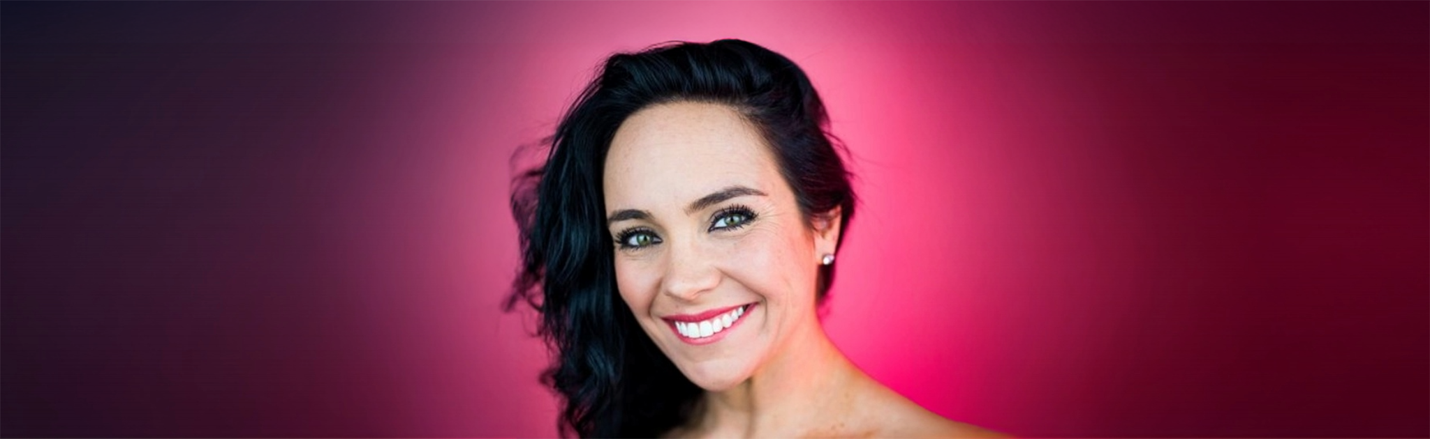 A headshot of Jo Nash on a magenta background.