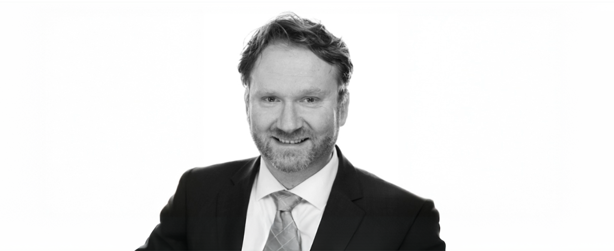 A black and white portrait image of Timothy Sherlock dressed in suit and tie.