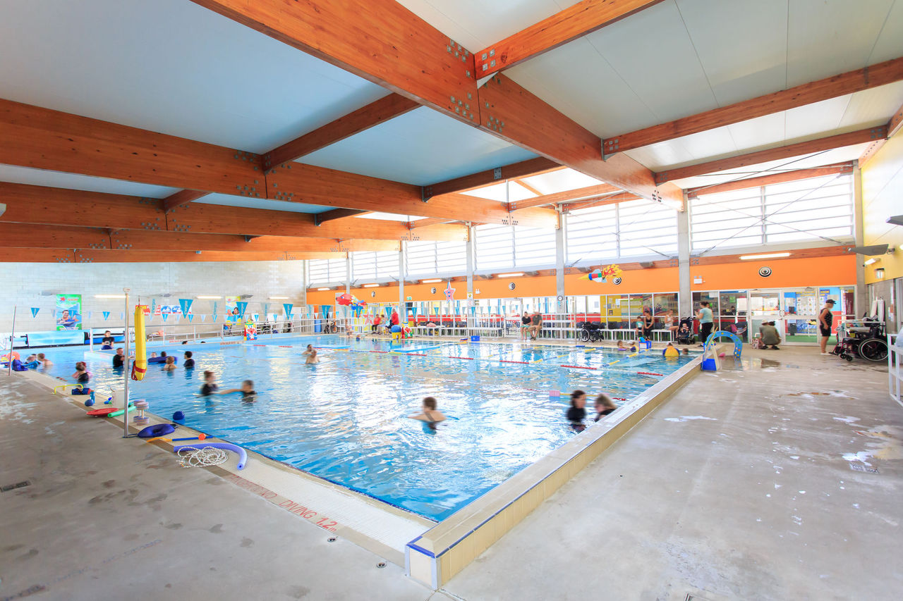 Indoor pool at Mt Gravatt East Swimming Pool with learn-to-swim class participants and teachers in pool.