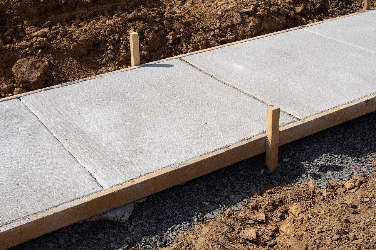 Freshly laid concrete footpath with timber frame.